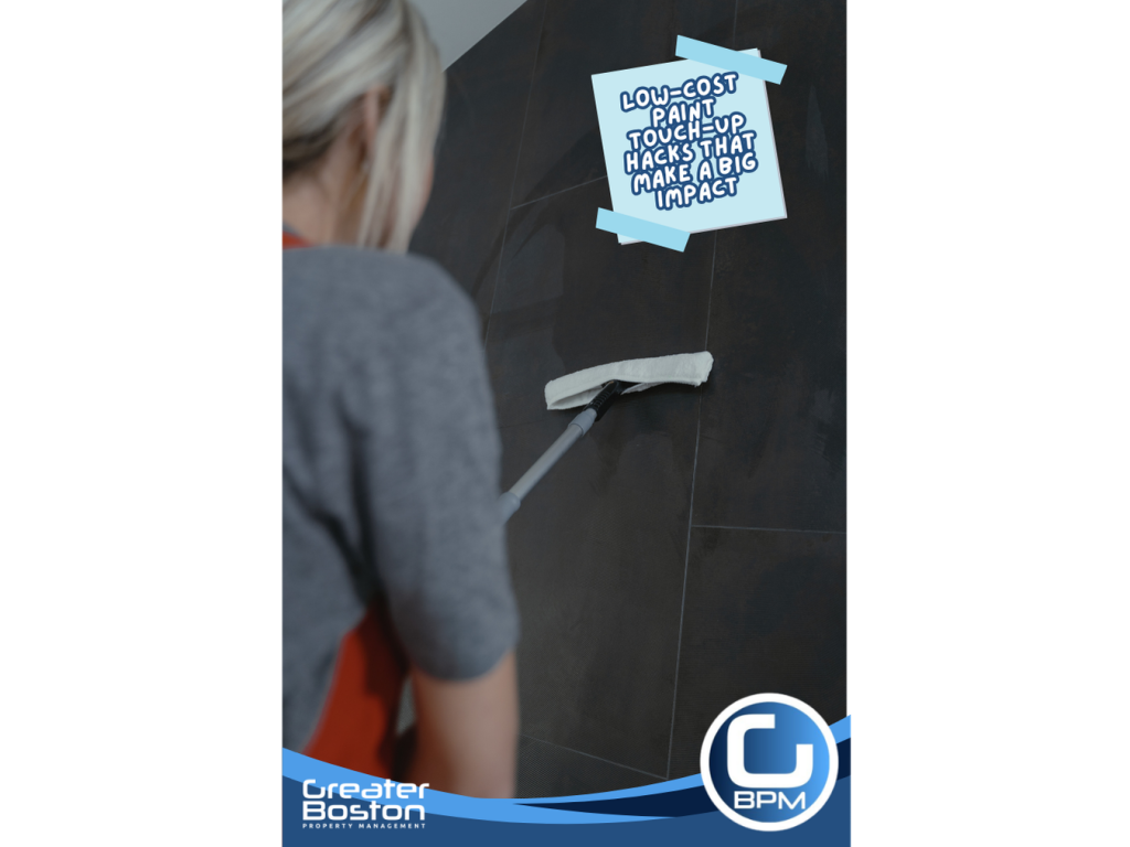Person cleaning a dark tiled wall with a mop before paint touch-up