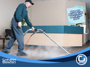 Professional cleaner in protective gear deep cleaning and deodorizing a rental unit carpet with a steam vacuum.