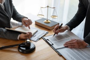 Legal consultation with contracts and justice scale–Massachusetts broker fee law for landlords and tenants