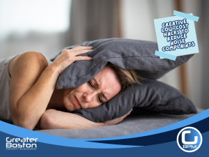 Woman covering ears with pillow, symbolizing noise complaints in rental properties.