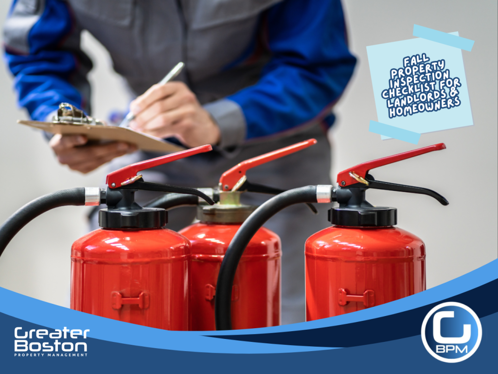 Inspector checking fire extinguishers during fall property safety inspection for landlords and homeowners