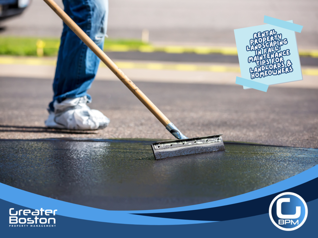 Worker sealing a residential driveway to prevent cracks during fall property maintenance