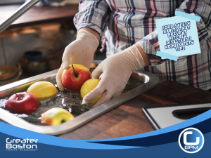 Person washing apples in kitchen sink while wearing gloves, demonstrating proper food safety and hygiene to prevent kitchen contamination and household accidents.