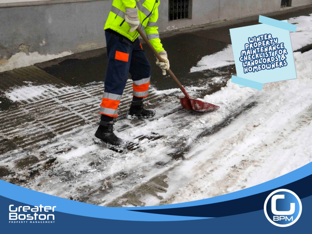 Worker clearing snow and ice from a sidewalk to reduce slip-and-fall risks during winter property maintenance.