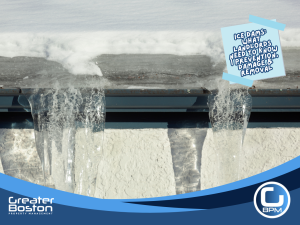 Ice dams and large icicles forming along a roof gutter, showing winter roof damage risk for rental properties.