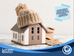 Mini house model wearing a winter hat symbolizing winterizing rental property for energy efficiency and cold weather protection.