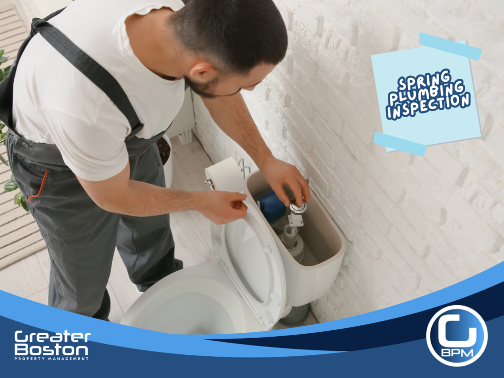 Inspecting toilet tank components to detect silent water leaks and prevent water waste in rental properties during spring plumbing inspection.