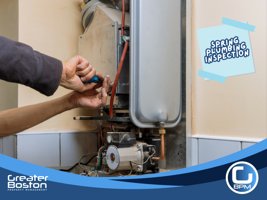 Inspecting water heater components for leaks, corrosion, and proper operation during spring plumbing maintenance in rental properties.