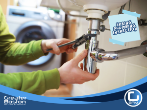 Inspecting and tightening under-sink plumbing connections to prevent leaks and water damage in rental properties during spring maintenance.