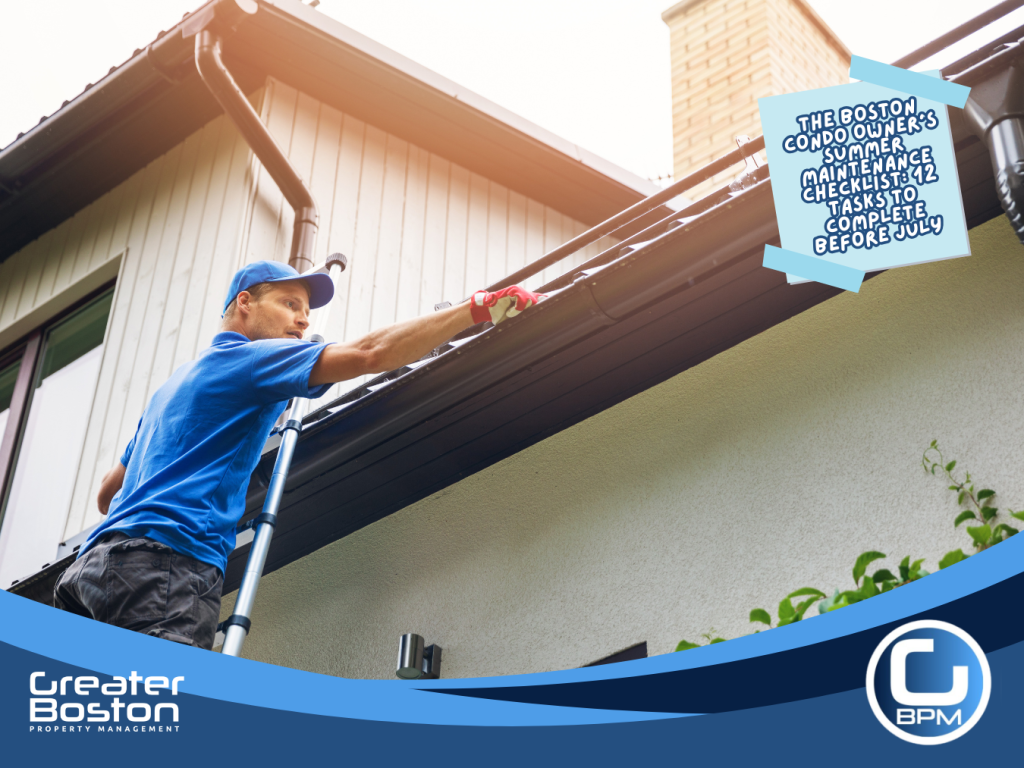 Licensed contractor on ladder inspecting and cleaning roof gutters on Boston condo building as part of summer exterior maintenance checklist and building envelope inspection before July 2026