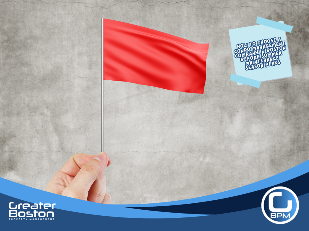 Hand holding red flag representing the critical warning signs and red flags Boston condo association trustees must identify when evaluating condo management companies before signing a contract in 2026
