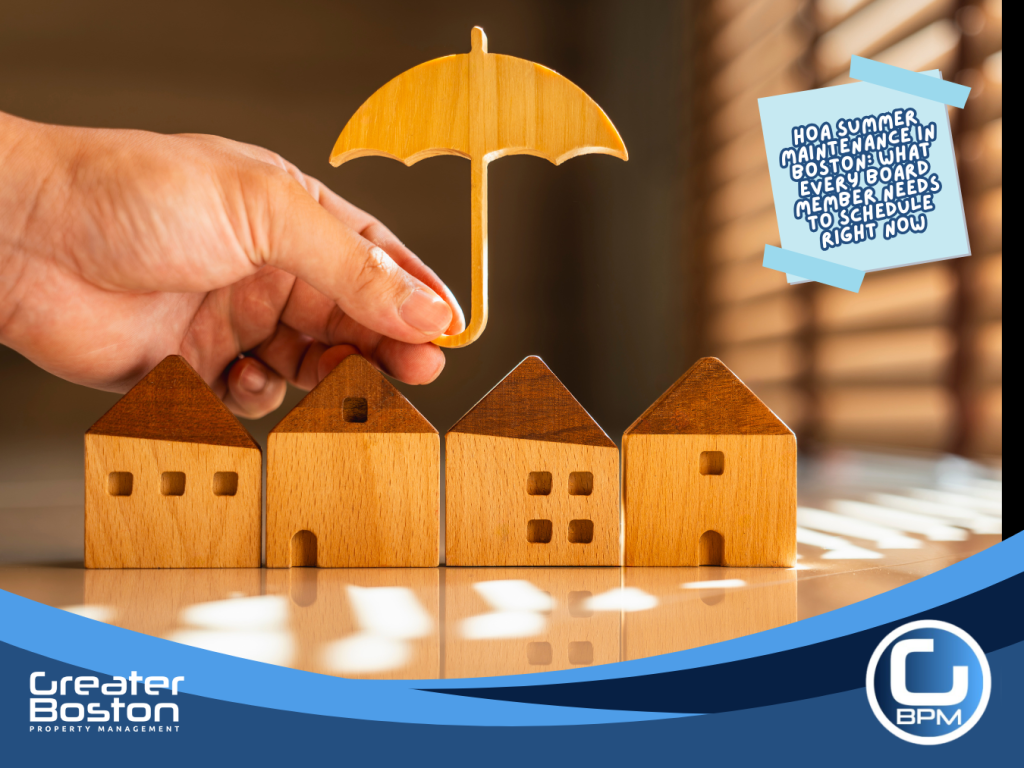 Boston HOA board member holding umbrella over wooden house models representing summer master insurance policy review and financial protection tasks for homeowners association trustees in 2026