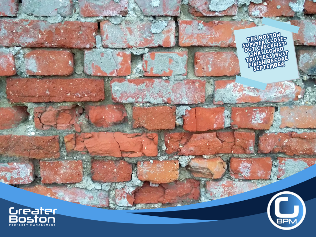 Severely deteriorated Boston condo building brick masonry with crumbling mortar joints and spalling brick faces revealed by summer thermal cycling representing the post-heat building assessment trustees must complete before September repointing window closes in 2026