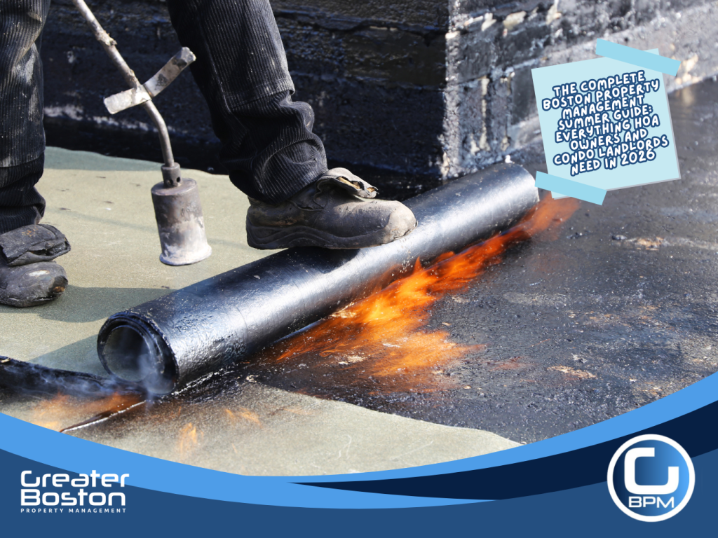 Licensed roofing contractor applying modified bitumen membrane with torch on Boston condo building flat roof representing summer building envelope inspection and heat-stressed roof repair that property management must prioritize in 2026